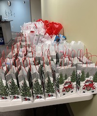 Bags of Christmas gifts sit on tables at WMed Health.